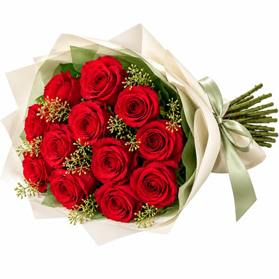 A dozen red roses wrapped in cream paper with a sage satin ribbon