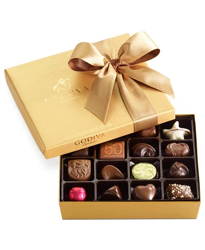 Gold gift box of assorted chocolates with a ribbon