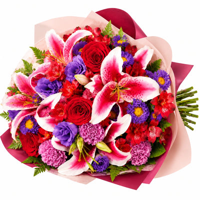 Bouquet of pink lilies, red roses, purple asters and carnations
